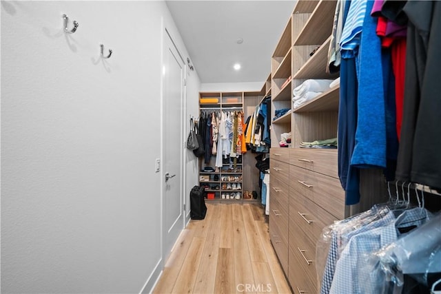 walk in closet featuring light wood finished floors