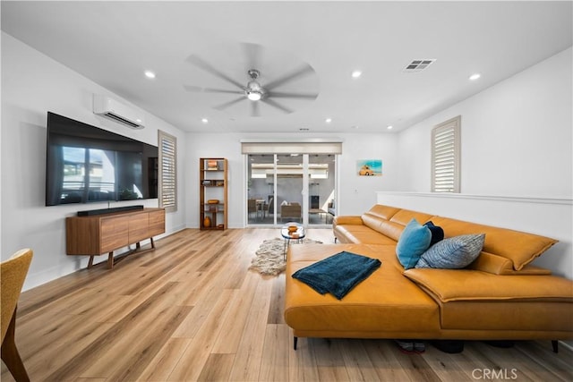 living room featuring light wood-style floors, recessed lighting, and visible vents