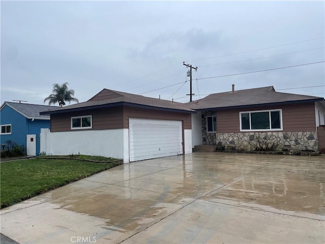 ranch-style house with a garage, stone siding, concrete driveway, and a front lawn