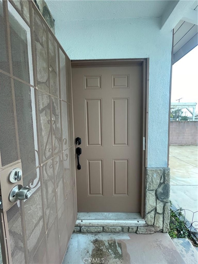 entrance to property with stucco siding