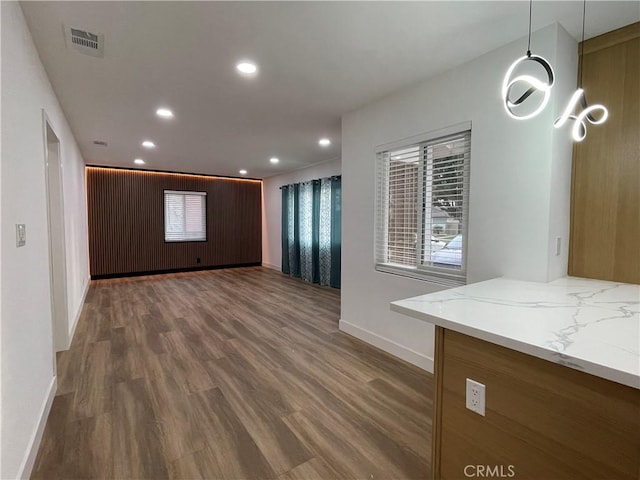 interior space featuring recessed lighting, visible vents, baseboards, and wood finished floors