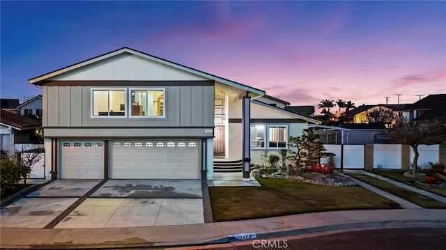 view of front of property featuring board and batten siding, fence, a garage, and driveway