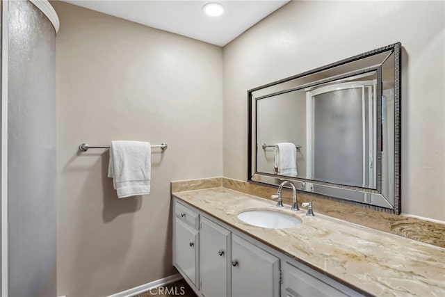 bathroom with vanity and baseboards