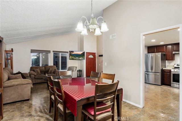 dining room with visible vents, a notable chandelier, a textured ceiling, baseboards, and lofted ceiling