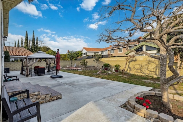 view of patio / terrace featuring a gazebo, a fenced backyard, and outdoor dining space