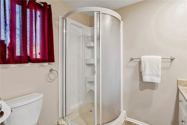 full bath featuring vanity, toilet, and a stall shower