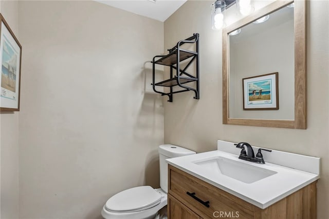 half bathroom featuring toilet and vanity