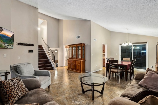 living room with visible vents, lofted ceiling, stairway, baseboards, and a chandelier