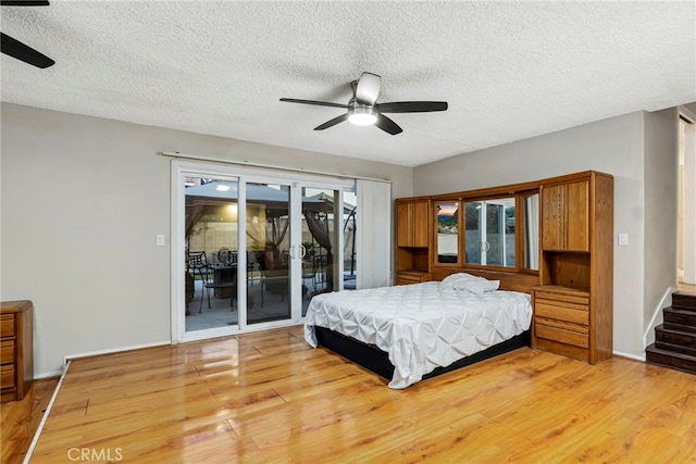 bedroom with access to exterior, light wood-type flooring, and ceiling fan