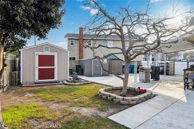 exterior space with an outdoor structure, a storage shed, and a fenced backyard