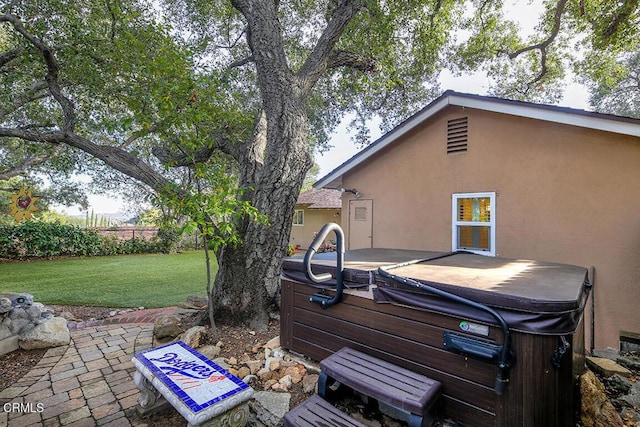 view of yard featuring a patio and a hot tub