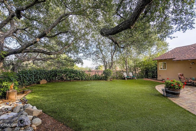 view of yard featuring a patio area and fence