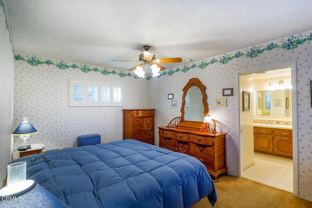 bedroom featuring light carpet, wallpapered walls, a ceiling fan, and a textured ceiling