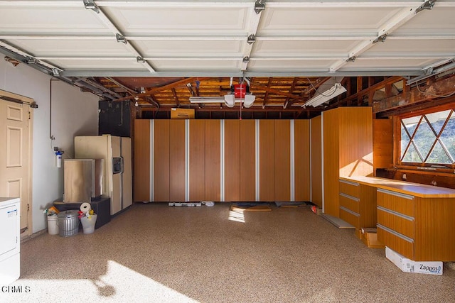 garage featuring washer / dryer and white fridge with ice dispenser