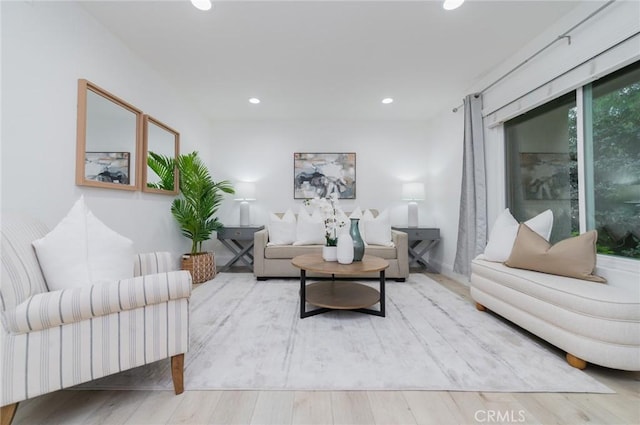 living area featuring wood finished floors and recessed lighting