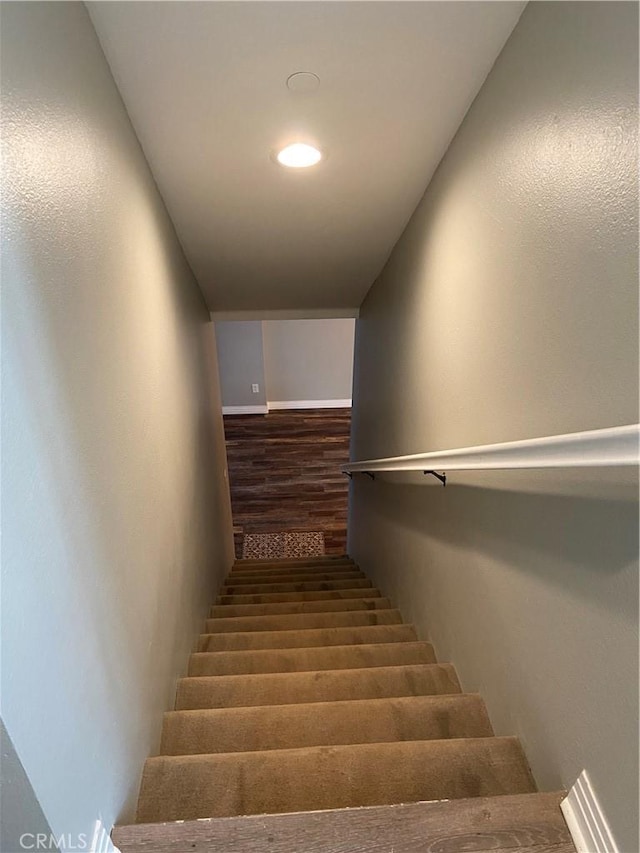 stairway featuring wood finished floors