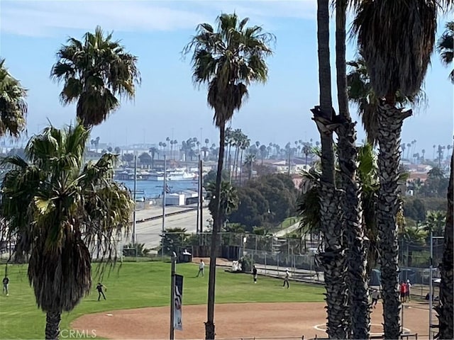 surrounding community featuring fence and a lawn