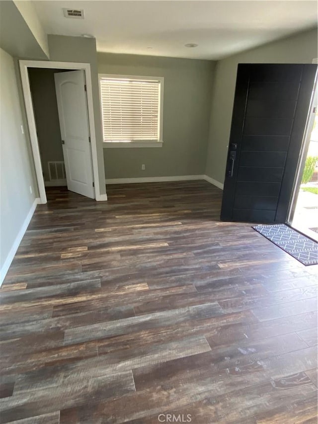 entryway featuring dark wood-style flooring, visible vents, and baseboards