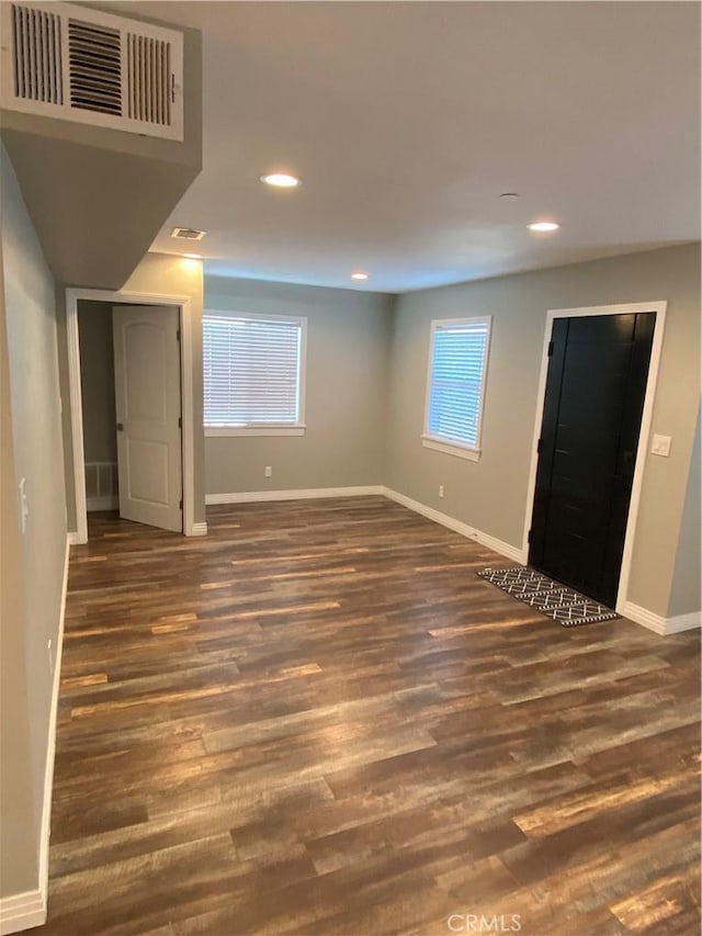 interior space with baseboards, visible vents, wood finished floors, and recessed lighting