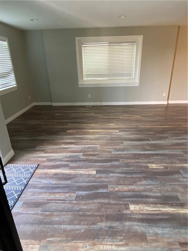 unfurnished room with wood finished floors and baseboards