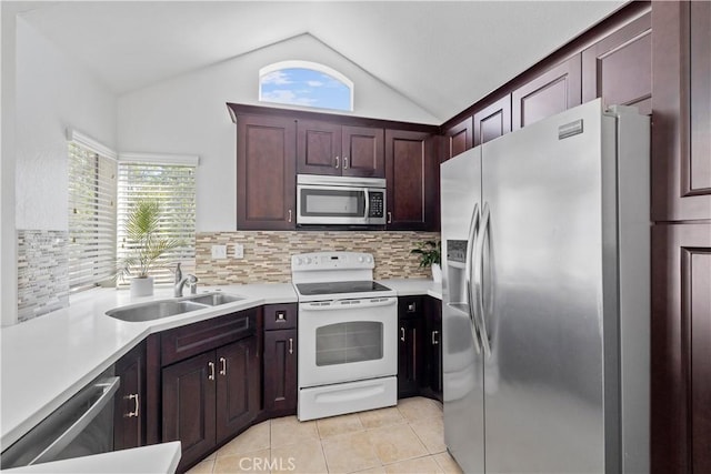 kitchen with plenty of natural light, stainless steel appliances, light countertops, a sink, and light tile patterned flooring