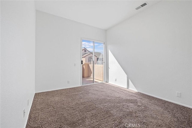 spare room with baseboards, visible vents, and carpet flooring