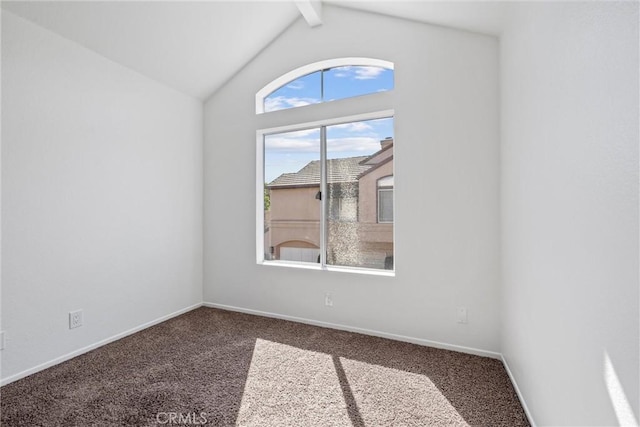 carpeted empty room featuring vaulted ceiling with beams and baseboards