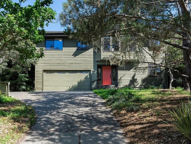 view of front of home with driveway and an attached garage