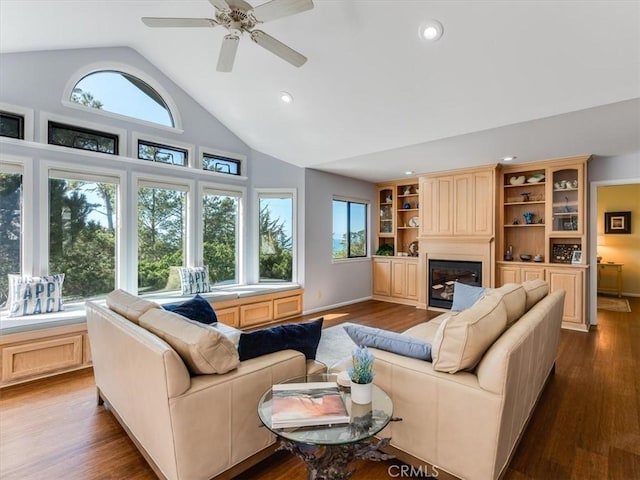 living room featuring recessed lighting, a ceiling fan, wood finished floors, and a glass covered fireplace