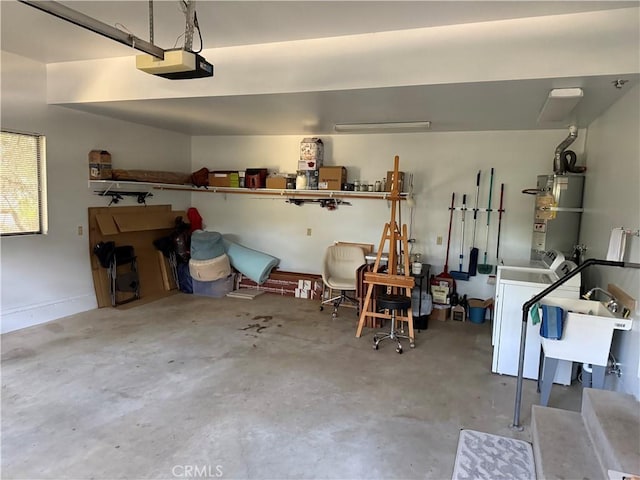 garage featuring a garage door opener, washer / dryer, and secured water heater