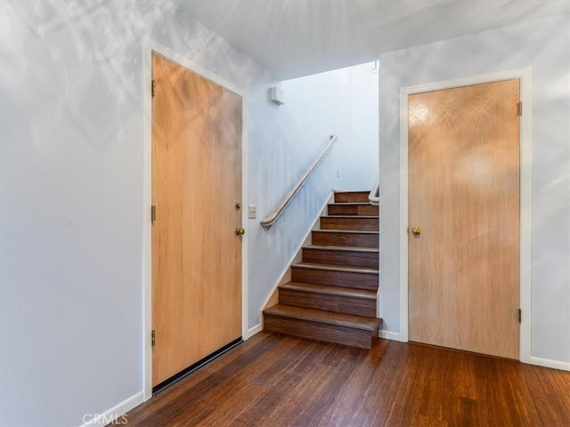 stairway featuring baseboards and wood finished floors