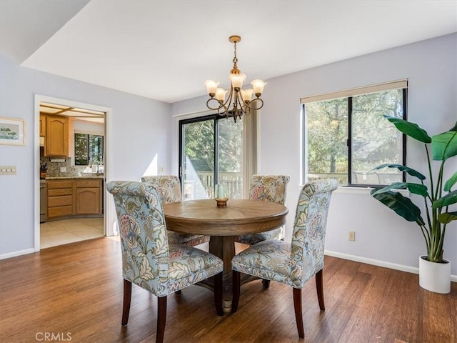 dining area with plenty of natural light, light wood-style flooring, and baseboards