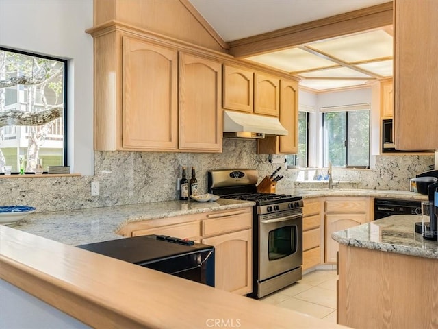 kitchen with light brown cabinets, a sink, under cabinet range hood, and gas range