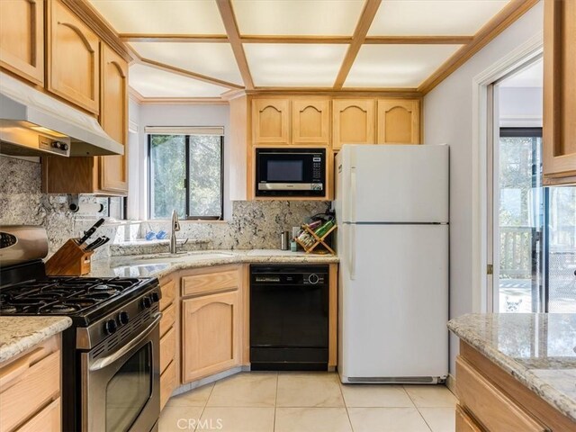 kitchen with freestanding refrigerator, stainless steel gas range, built in microwave, dishwasher, and under cabinet range hood