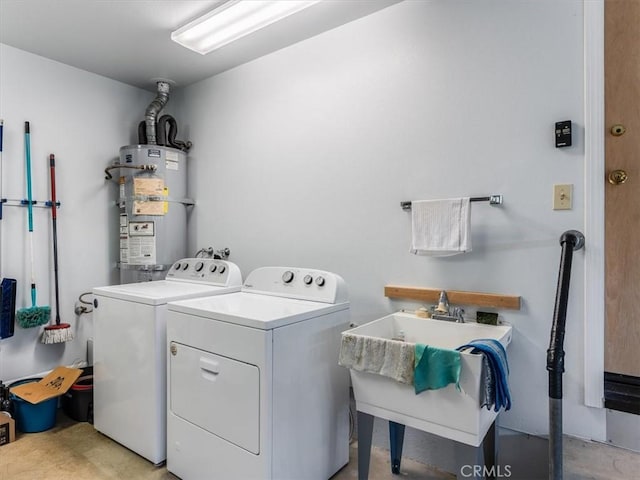 laundry room with washer and dryer, strapped water heater, a sink, and laundry area