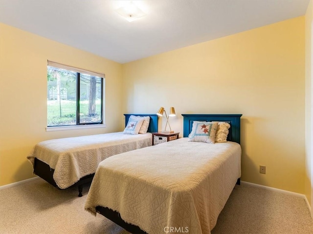 bedroom with carpet floors and baseboards