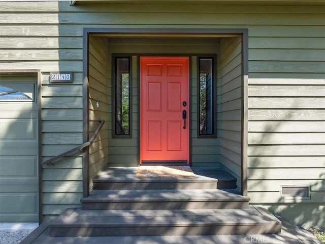 view of exterior entry featuring a garage