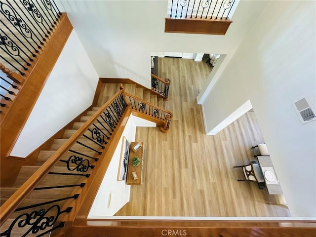 stairway with a high ceiling and visible vents