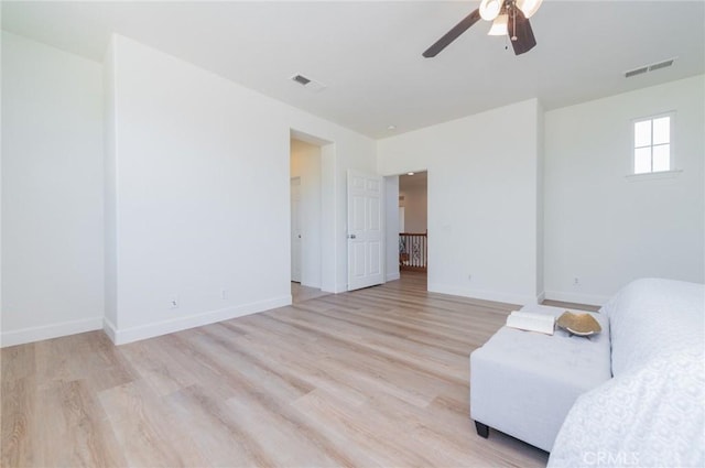 interior space with baseboards, visible vents, and light wood-type flooring