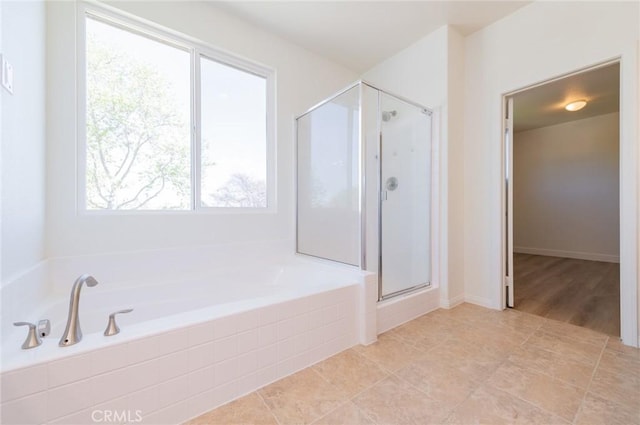 full bath featuring a shower stall and a garden tub