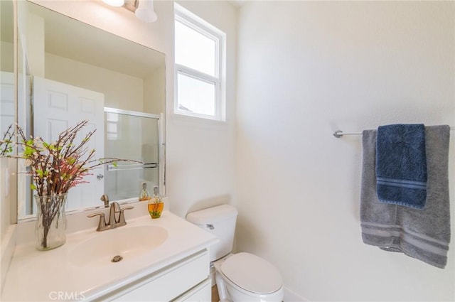 full bath with a shower stall, toilet, and vanity