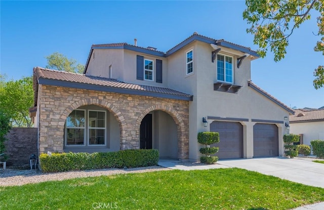 mediterranean / spanish-style home with stone siding, stucco siding, a tiled roof, and concrete driveway