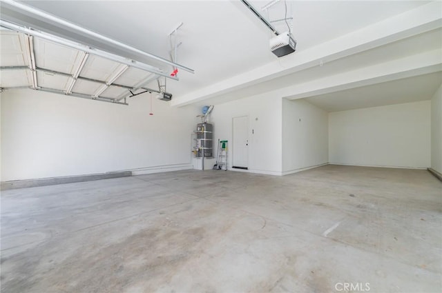 garage featuring secured water heater and a garage door opener