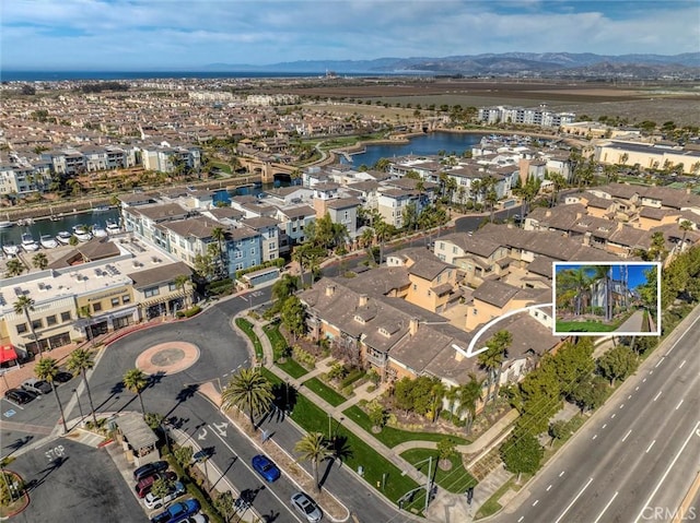 aerial view featuring a residential view and a water and mountain view