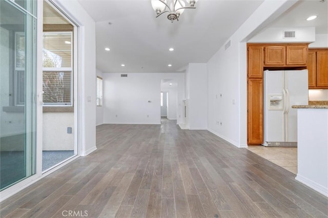 unfurnished living room with recessed lighting, visible vents, and light wood-style floors