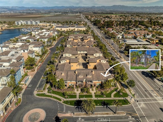 bird's eye view with a residential view and a water and mountain view