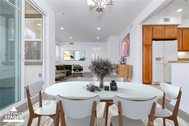 dining area featuring recessed lighting, visible vents, and a notable chandelier