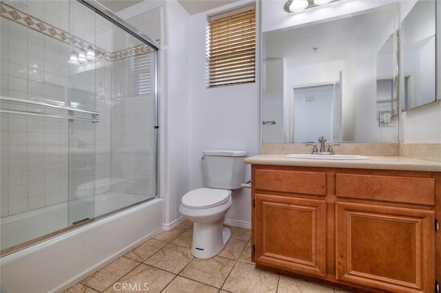 full bathroom featuring shower / bath combination with glass door, toilet, vanity, tile patterned flooring, and baseboards