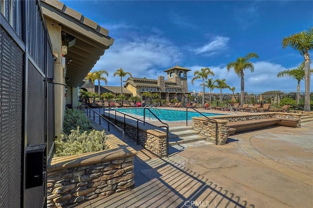 pool featuring a patio area and fence