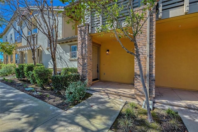 doorway to property with stucco siding